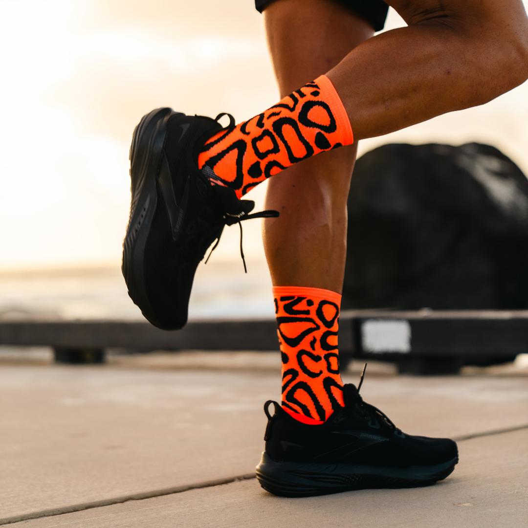 Image of person wearing Lightfeet Performance Scribbles Orange Black Crew Socks