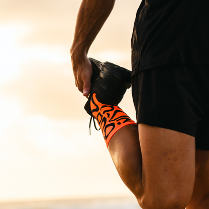 Image of person wearing Lightfeet Performance Scribbles Orange Black Crew Socks 