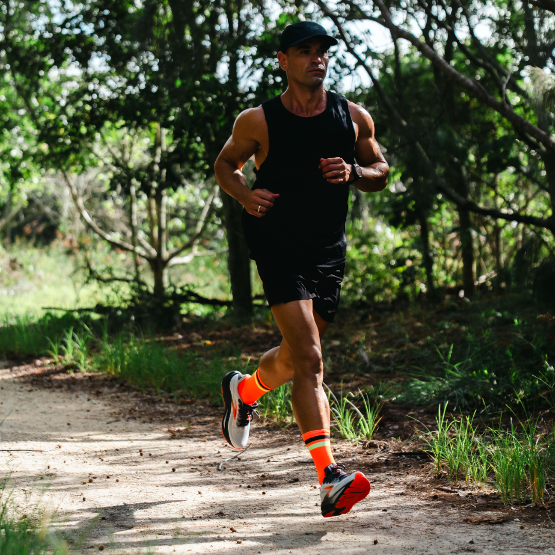 Image of person wearing Lightfeet Performance 2 Stripes Orange Black Yellow Crew Socks 