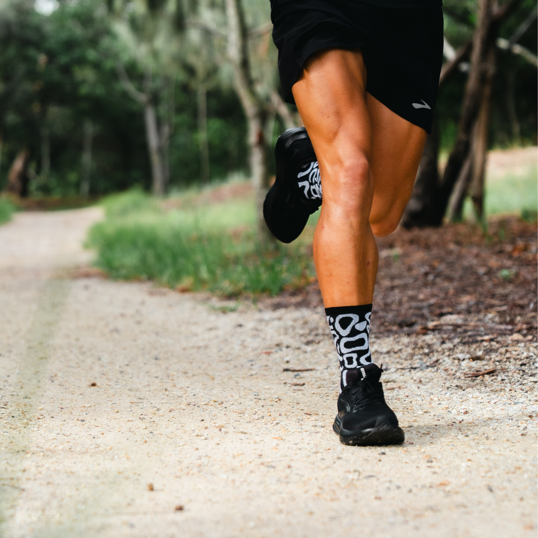 Image of person wearing Lightfeet Performance Scribbles Black White Crew Socks 