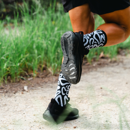 Image of person wearing Lightfeet Performance Scribbles Black White Crew Socks 