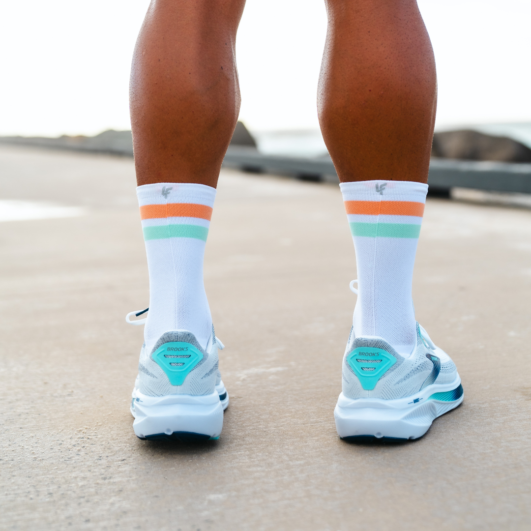 Image of person wearing Lightfeet Performance 2 Stripes White Coral Glacier Crew Socks 