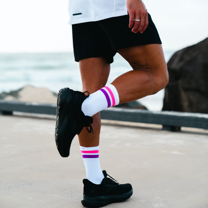Image of person wearing Lightfeet Performance 2 Stripes White Pink Purple Crew Socks 