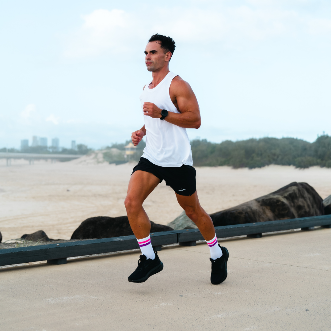 Image of person wearing Lightfeet Performance 2 Stripes White Pink Purple Crew Socks 