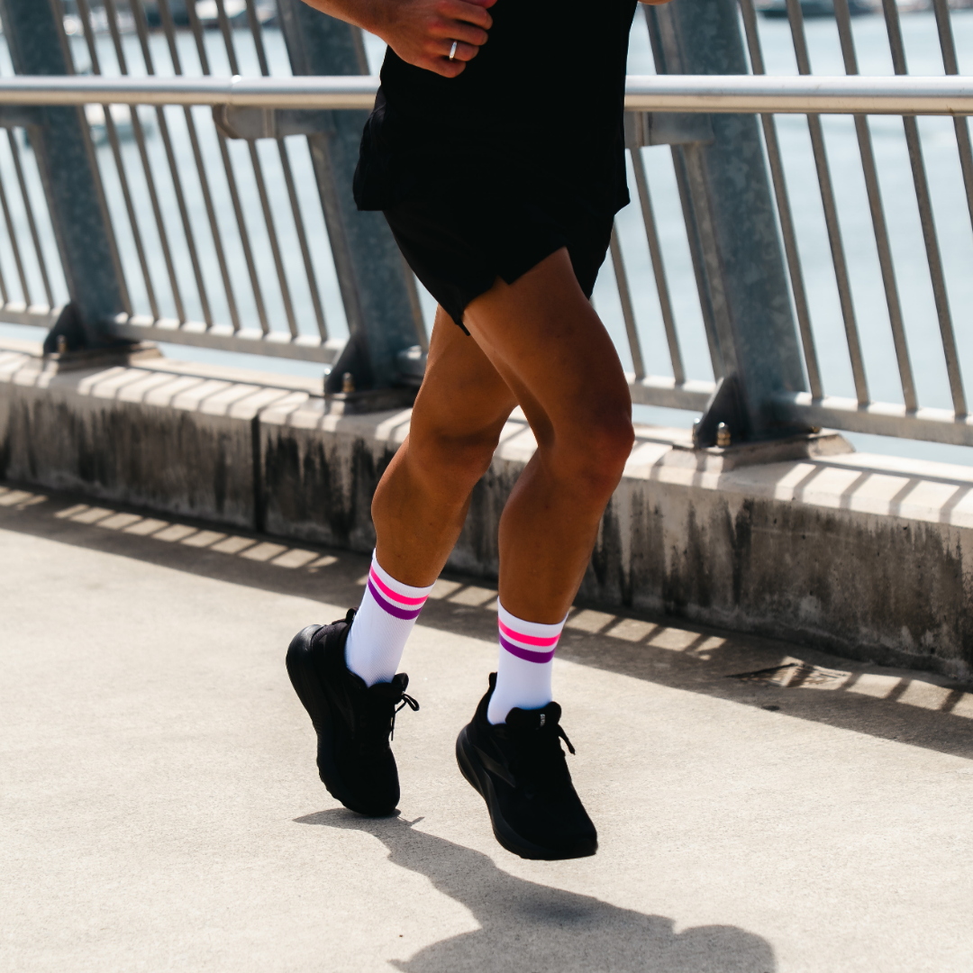 Image of person wearing Lightfeet Performance 2 Stripes White Pink Purple Crew Socks 