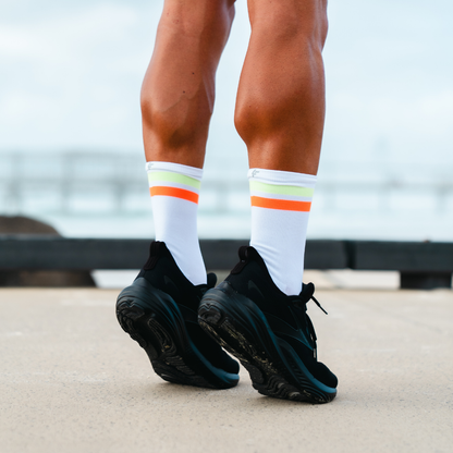 Image of person wearing Lightfeet Performance 2 Stripes White Yellow Orange Crew Socks 