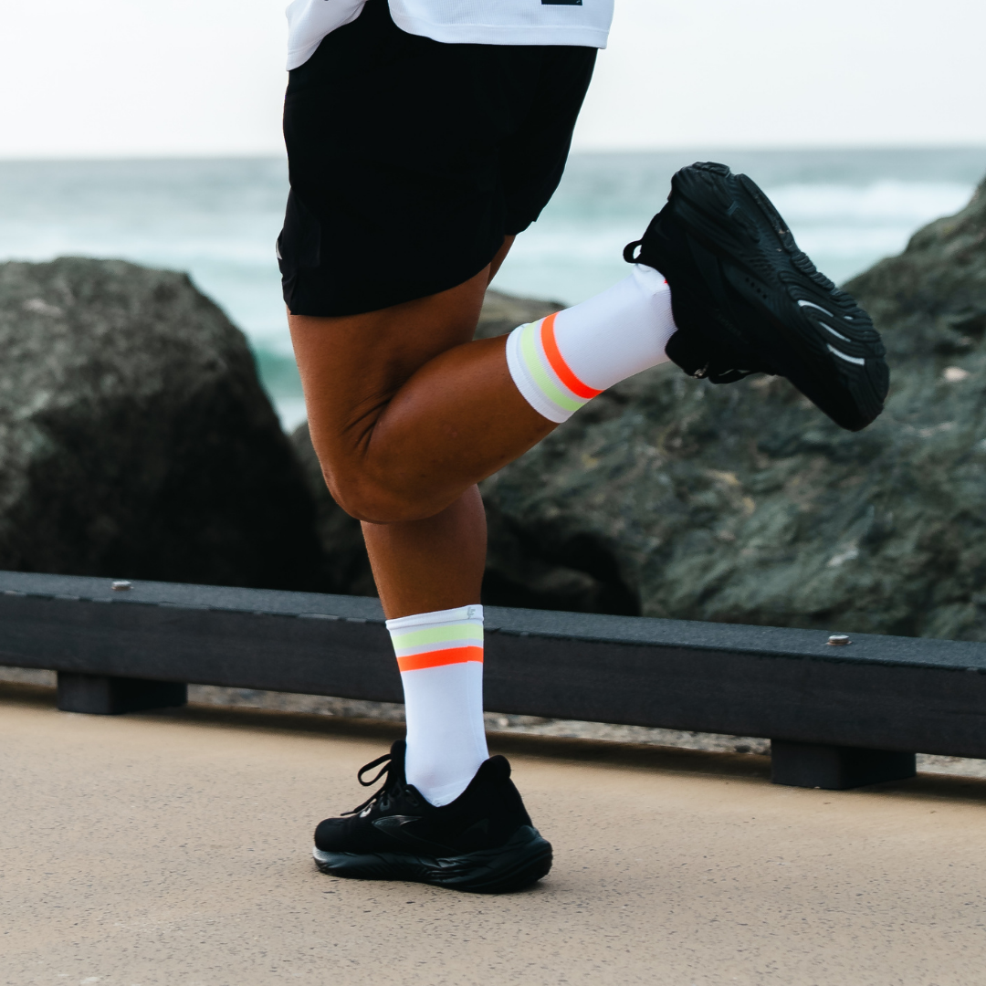 Image of person wearing Lightfeet Performance 2 Stripes White Yellow Orange Crew Socks 