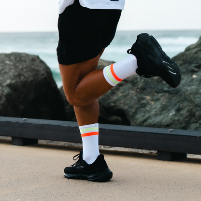 Image of person wearing Lightfeet Performance 2 Stripes White Yellow Orange Crew Socks 
