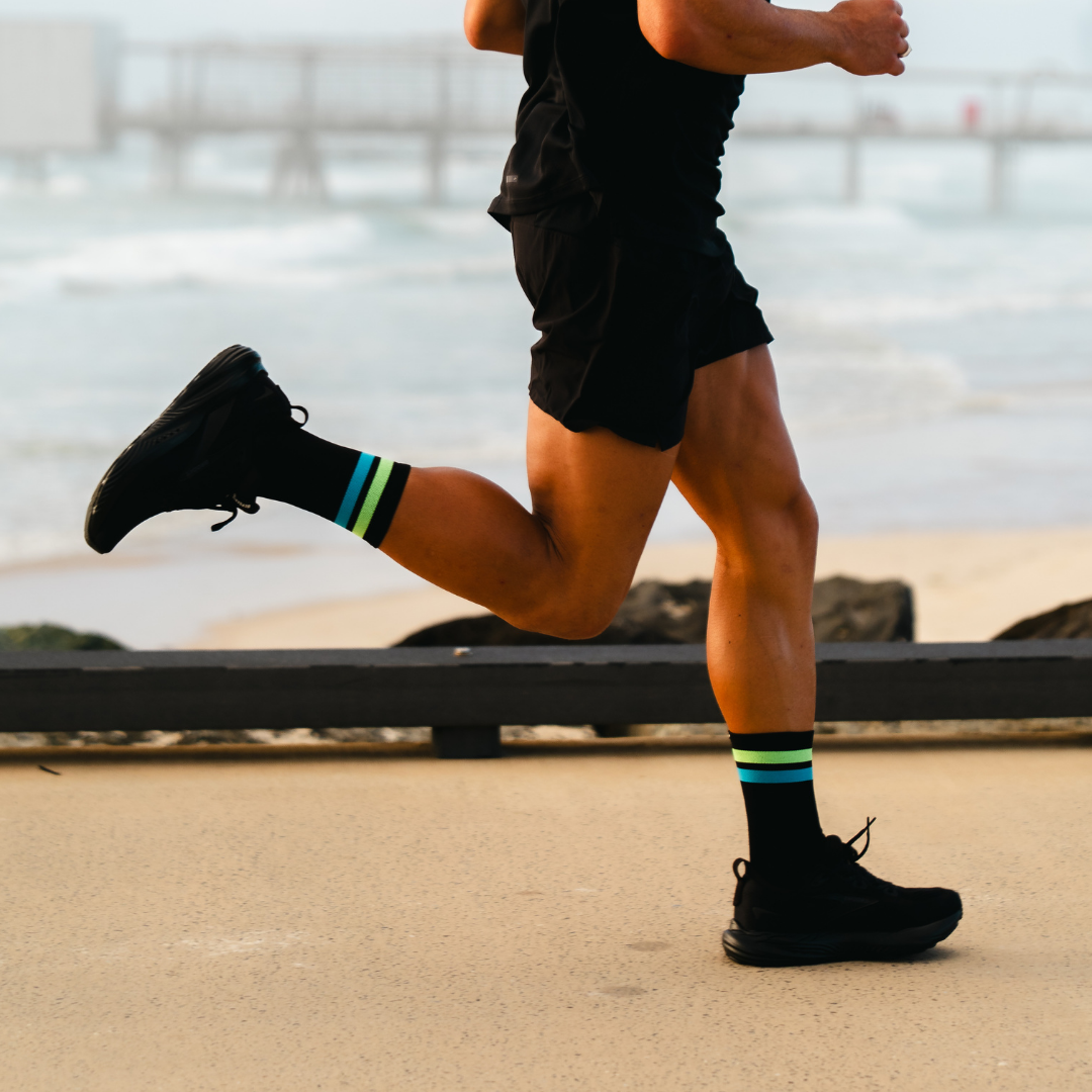 Image of person wearing Lightfeet Performance 2 Stripes Black Yellow Aqua Crew Socks 