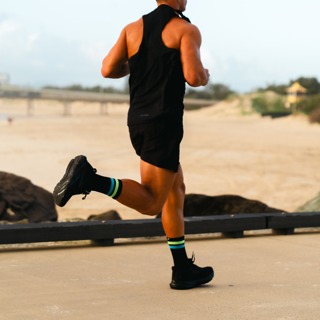Image of person wearing Lightfeet Performance 2 Stripes Black Yellow Aqua Crew Socks 