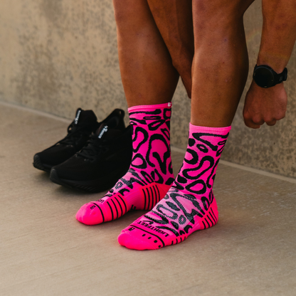 Image of person wearing Lightfeet Performance Scribbles Pink Black Crew Socks 
