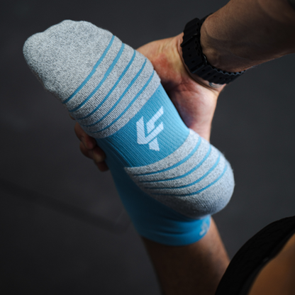 Person wearing Lightfeet Performance Soft Blue Quarter Crew Socks 